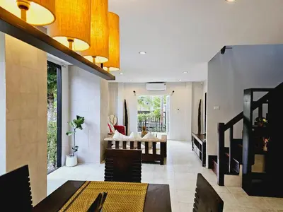 a living room with a couch and a table at KRAAM VILLAS in Thalang
