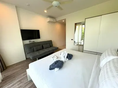 a hotel room with a bed with towels on it at Private apartment at Oceana Resort by Lofty in Kamala Beach