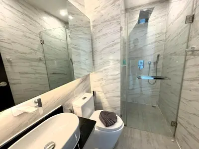 a bathroom with a shower and a toilet and a sink at Private apartment at Oceana Resort by Lofty in Kamala Beach