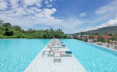 a swimming pool with lounge chairs and a resort at Private apartment at Oceana Resort by Lofty in Kamala Beach