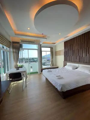 a large bedroom with a large bed and a table at Studio 1 Chambre lumineux avec vue à 180° in Ban Klang