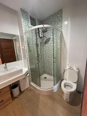 a bathroom with a shower and a toilet and a sink at Studio 1 Chambre lumineux avec vue à 180° in Ban Klang