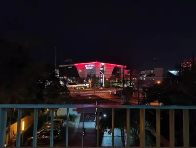 a stadium lit up at night with a red light at 中央公寓 1 bed & Twin beds in Ban Rangeng