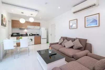 a living room with a couch and a table at The Lago apartments 2bd in Phuket Town