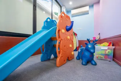 a childs play area with a slide and toys at The Lago apartments 2bd in Phuket Town