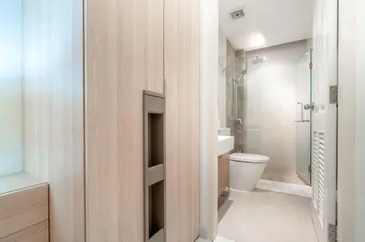 a bathroom with a toilet and a glass shower at The Lago apartments 2bd in Phuket Town
