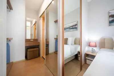 a bedroom with a mirror next to a bed at Private apartment Zcape2 near Boat Avenue in Bang Tao Beach