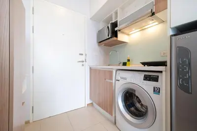 a small kitchen with a washing machine in it at Private apartment Zcape2 near Boat Avenue in Bang Tao Beach