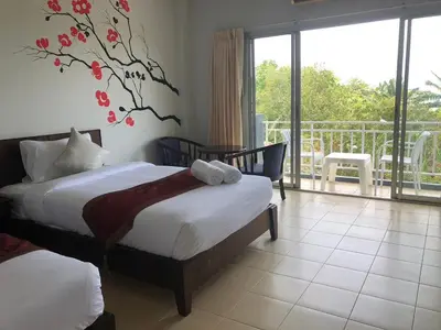 a bedroom with two beds and a balcony at NAKA GUEST HOUSE in Ban Ko Kwang