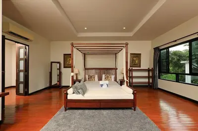 a large bedroom with a bed and a large window at VILLA Salika Thai Balinese pool villa RAWAI in Rawai Beach