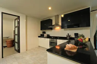 a kitchen with a black counter top in a room at VILLA Salika Thai Balinese pool villa RAWAI in Rawai Beach