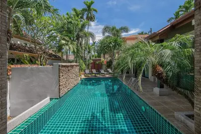 a swimming pool in the middle of a building at VILLA Salika Thai Balinese pool villa RAWAI in Rawai Beach