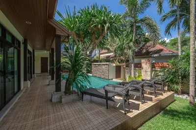 an outdoor patio with chairs and a swimming pool at VILLA Salika Thai Balinese pool villa RAWAI in Rawai Beach
