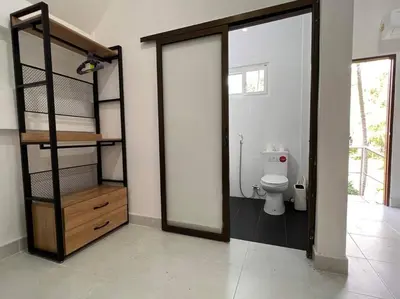 a bathroom with a toilet and a room with a doorway at Charming Villa Suite with Balcony near Beach in Patong Beach