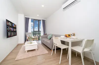 a living room with a table and a couch at Laguna BangTao Beach Skypark Apartment in Phuket Town