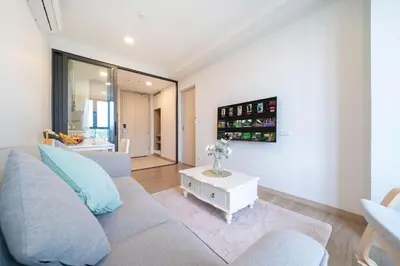 a living room with a couch and a table at Laguna BangTao Beach Skypark Apartment in Phuket Town