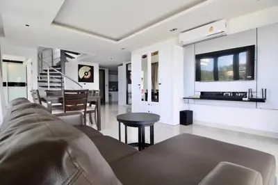 a living room with a couch and a table at Luxury Rooftop Penthouse in Kamala Beach