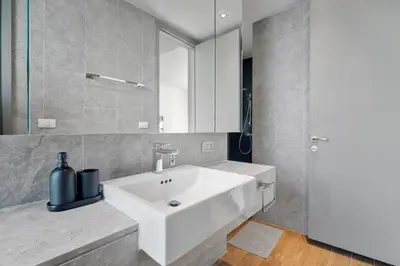 a bathroom with a white sink and a mirror at 5 Bdr 18 meter Pool villa in Laguna Phuket in Phuket Town