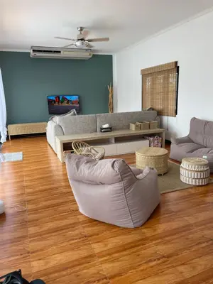 a living room with a couch and a table at Villa KEWALYN in Chalong
