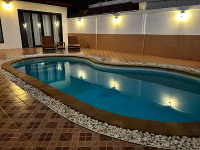 a pool in the middle of a building at Villa KEWALYN in Chalong