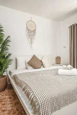 a white bedroom with a large bed with a blanket at Nai Harn beach Villa 2 bdr in Rawai Beach