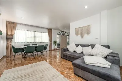 a living room with a couch and a table at Nai Harn beach Villa 2 bdr in Rawai Beach