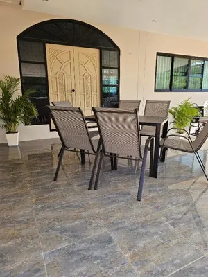 a group of chairs and tables in a building at Nai Harn beach Villa 2 bdr in Rawai Beach