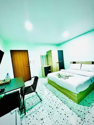 a bedroom with a bed and a desk and a desk at BLUE PEARL SHORE in Patong Beach