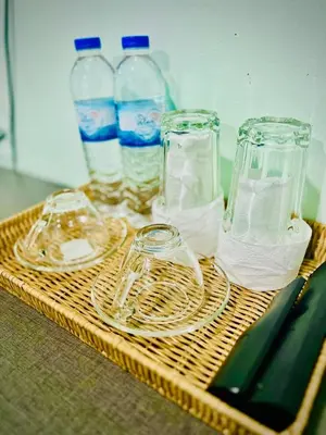 a tray with glasses and water bottles on a table at BLUE PEARL SHORE in Patong Beach
