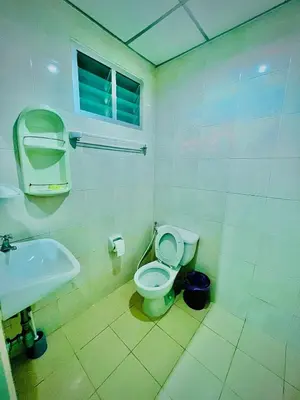 a bathroom with a toilet and a sink at BLUE PEARL SHORE in Patong Beach