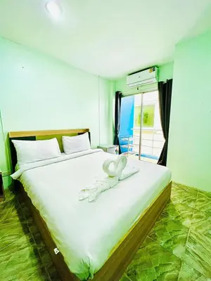a bedroom with a bed with a white object on it at BLUE PEARL SHORE in Patong Beach
