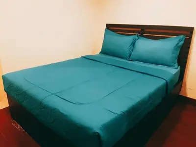 a blue bed with blue pillows in a room at Yada Resort Koh Yao Noi in Ko Yao Noi