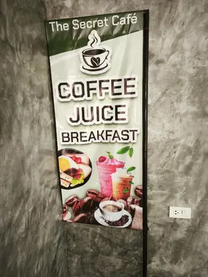a sign for a coffee juice breakfast on a wall at The Secret Garden Koh Yao Yai in Ko Yao Yai