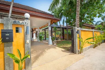 an entrance to a house with a fence at Tropical 3BR Pool Villa Prima, just 5min Drive to NaiHarn and Rawai Beach in Rawai Beach