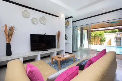 a living room with a couch and a tv at Tropical 3BR Pool Villa Prima, just 5min Drive to NaiHarn and Rawai Beach in Rawai Beach