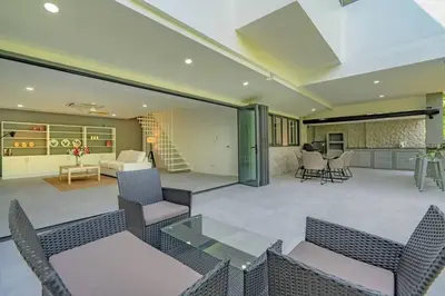an open living room with chairs and a couch at Ray Ray Villa by G Estate Phuket in Kata Beach