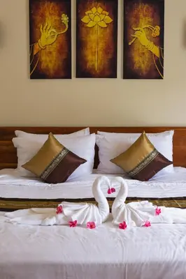 two swans are sitting on top of a bed at Wow !! Super Cool !! Jungle View Pool Villa !! Krabi - Thailand in Krabi town