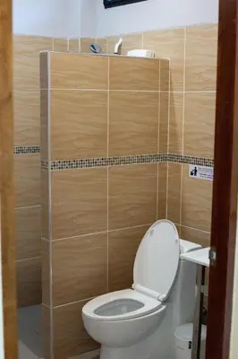 a bathroom with a toilet with wooden walls at Wow !! Super Cool !! Jungle View Pool Villa !! Krabi - Thailand in Krabi town