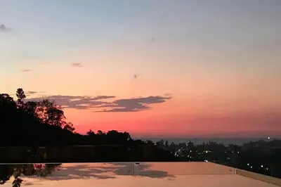a sunset over a swimming pool with the sky at 360* Ultimate Penthouse Entire TOP FLOOR and RESORT with GREAT AMENITIES in Kamala Beach