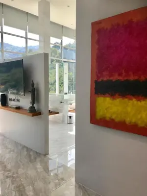 a living room with a painting on the wall at 360* Ultimate Penthouse Entire TOP FLOOR and RESORT with GREAT AMENITIES in Kamala Beach