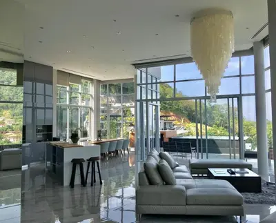 a large living room with a couch and a table at 360* Ultimate Penthouse Entire TOP FLOOR and RESORT with GREAT AMENITIES in Kamala Beach