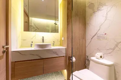 a bathroom with a sink and a toilet at Stylish 1 Bedroom Apartment with Golf View, Steps from Bang Tao Beach, Allamanda Laguna in Bang Tao Beach
