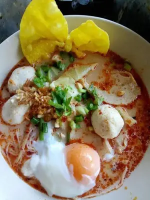 a bowl of food with eggs and vegetables on top at Kanda Hill Resort in Ban Na Sok
