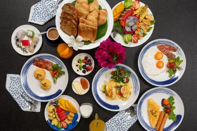 a group of plates of food on a table at Summer Estate Villa in Pilai Beach