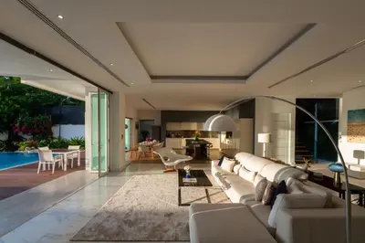 a living room with a large couch and a table at Summer Estate Villa in Pilai Beach