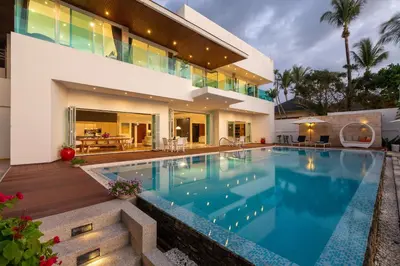 a large house with a swimming pool in front of it at Summer Estate Villa in Pilai Beach