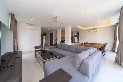 a living room with a couch and a table at 4bdr pool villa in Laguna Park 2 in Phuket Town