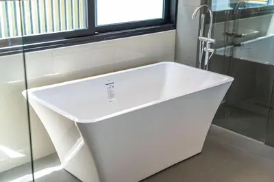 a white bath tub in a bathroom with a window at 4bdr pool villa in Laguna Park 2 in Phuket Town