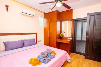 a bedroom with a bed with two teddy bears on it at Seaside Haven Karon in Karon Beach