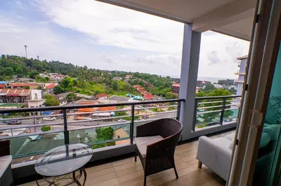 a balcony with a view of a city at Seaside Haven Karon in Karon Beach